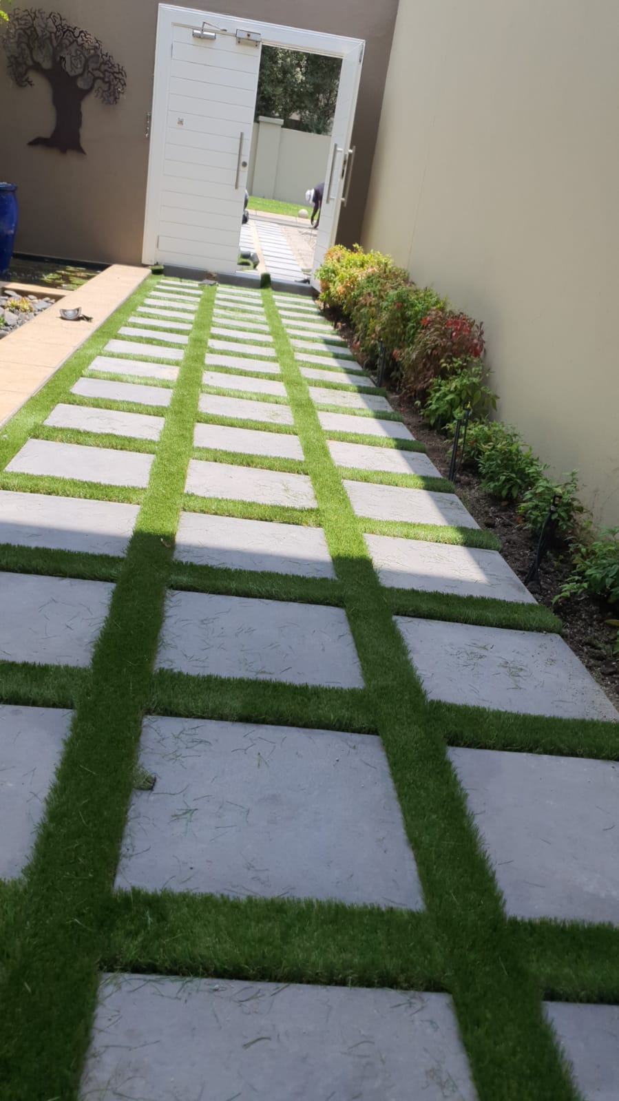 Artificial grass with decorative block work